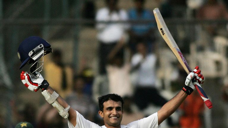 Indian cricketer Sourav Ganguly celebrates his century (100 runs) as Pakistani cricketer Kamran Akmal looks on during the first day of the third Test