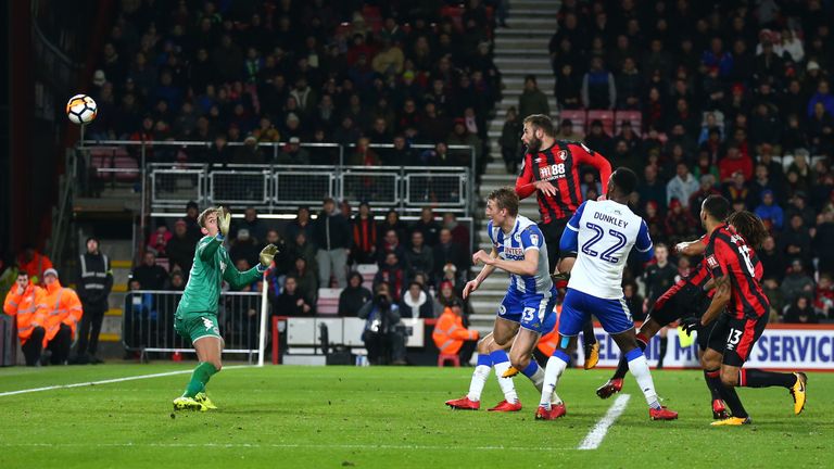 Steve Cook's late header earned Bournemouth a replay after coming from two goals down to draw with Wigan