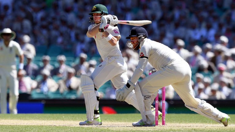 Australia's batsman Steve Smith (C) swings a ball to leg as England wicketkeeper Jonny Bairstow (R) looks on on the second day of the fifth Ashes cricket T