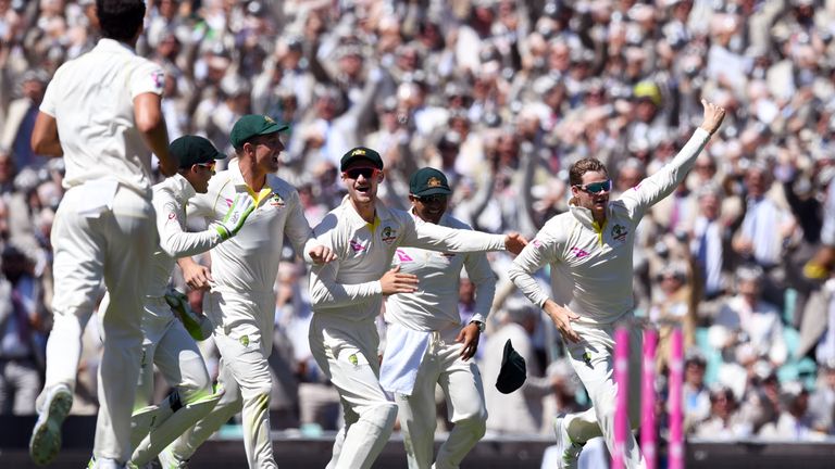 Australia's captain Steve Smith (R) celebrates with teammates after taking a catch to dismiss England batsman David Malan on the second day of the fifth As