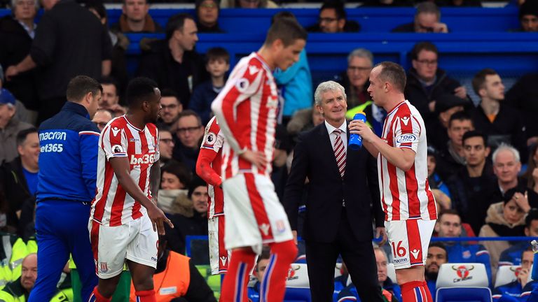 Stoke City manager Mark Hughes speaks to Charlie Adam during Saturday's defeat at Chelsea