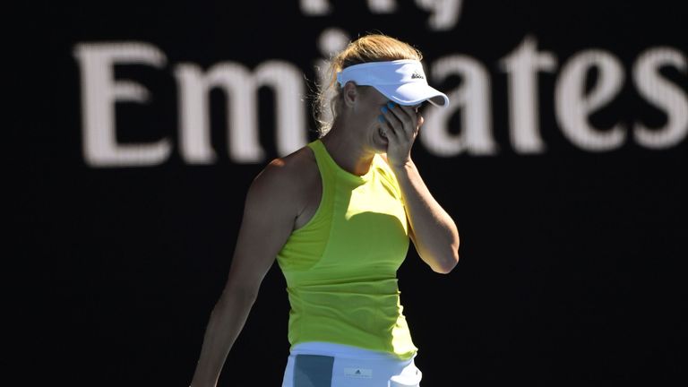 Denmark's Caroline Wozniacki reacts after beating Croatia's Jana Fett in their women's singles second round match on day three of the Australian Open
