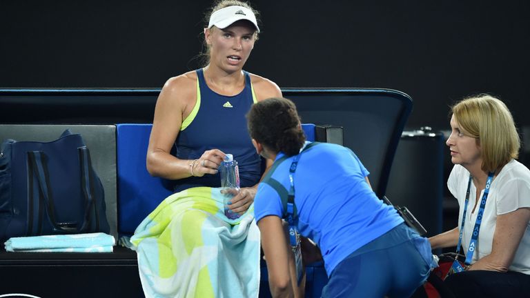 Denmark's Caroline Wozniacki receives medical attention against Romania's Simona Halep during their women's singles final at the Australian Open