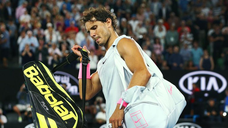 Rafael Nadal leaves court after he pulling out in the fifth set due to an injury in his quarter-final match against Marin Cilic