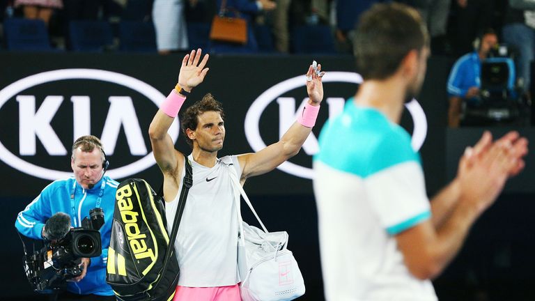 Rafa Nadal waves to the crowd after pulling out in the fifth set due to injury in his quarter-final match against Marin Cilic