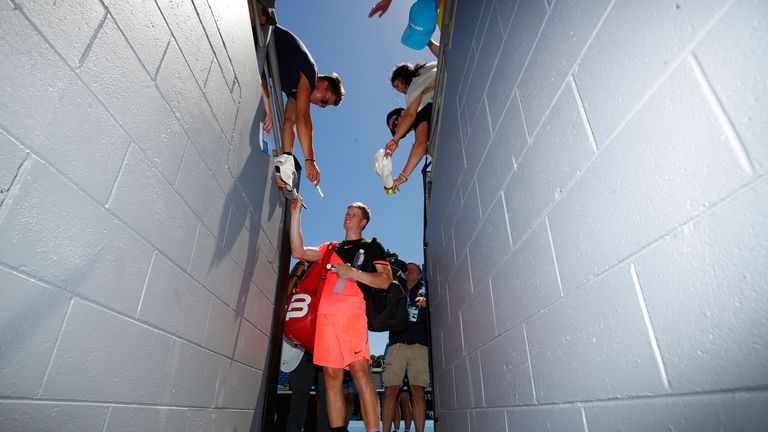 Kyle Edmund of Great Britain signs autographs for fans after winning his third round match against Nikoloz Basilashvili