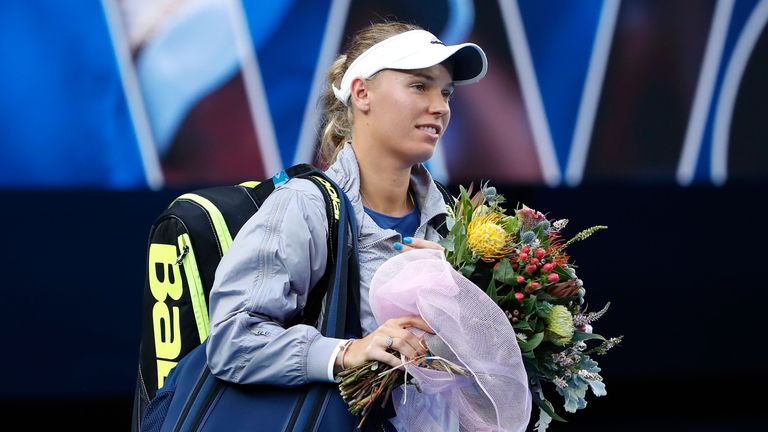 Caroline Wozniacki of Denmark walks on to the court ahead of her women's singles final against Simona Halep of Romania 