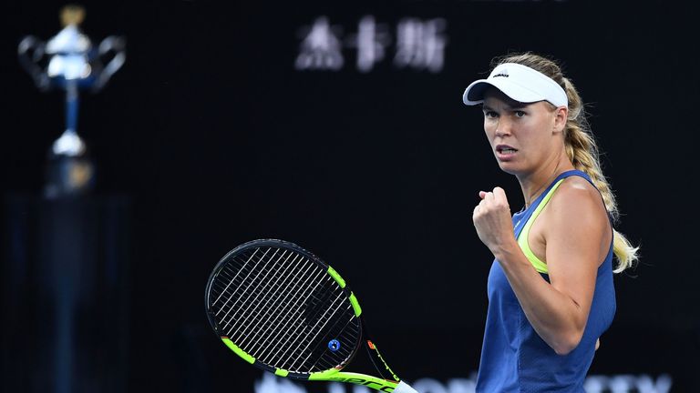 Caroline Wozniacki of Denmark celebrates winning a point in her women's singles final against Simona Halep of Romania