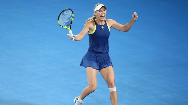 Caroline Wozniacki of Denmark celebrates winning championship point in her women's singles final against Simona Halep