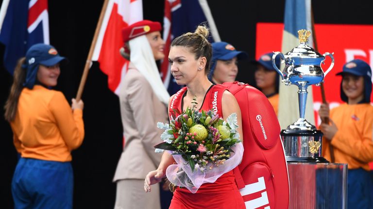 Simona Halep of Romania walks on to the court ahead of her women's singles final against Caroline Wozniacki of Denmark