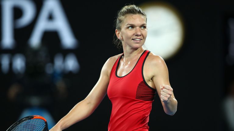 Simona Halep of Romania celebrates winning set point in her women's singles final against Caroline Wozniacki of Denmark