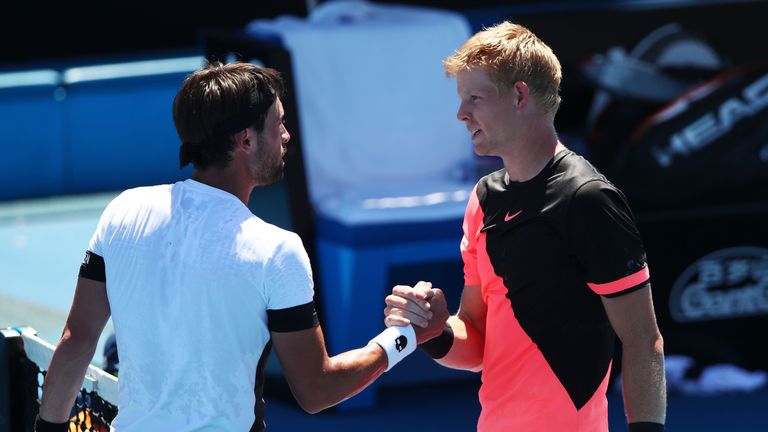 Nikoloz Basilashvili (L) of Georgia congratulates Kyle Edmund of Great Britain after Edmund won their third round match