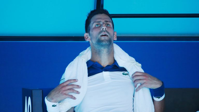 Novak Djokovic of Serbia attempts to cool down between games in his second round match against Gael Monfils of France