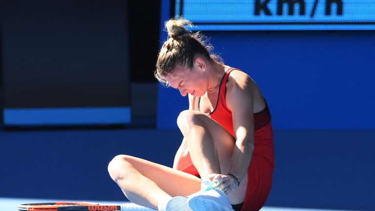 Simona Halep of Romania struggles after injuring her ankle in her first round match against  Destanee Aiava of Australia
