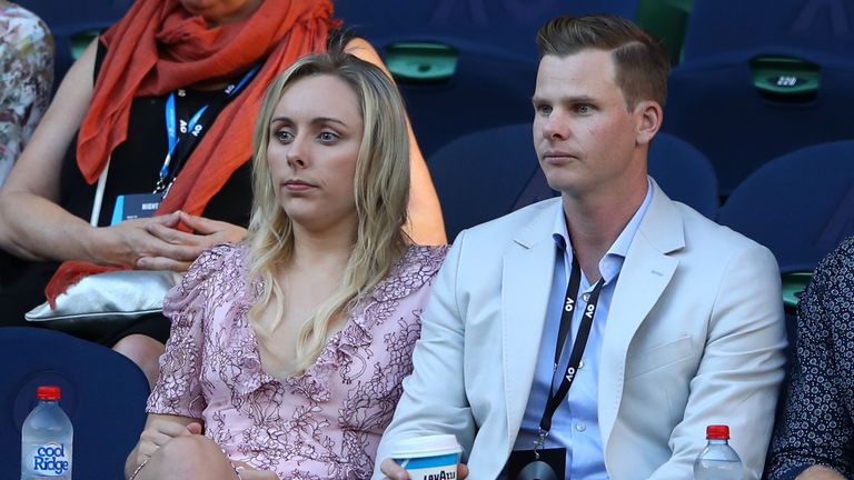 Australian cricket captain Steve Smith and his fiancee Dani Willis watch the quarter final match between Rafael Nadal