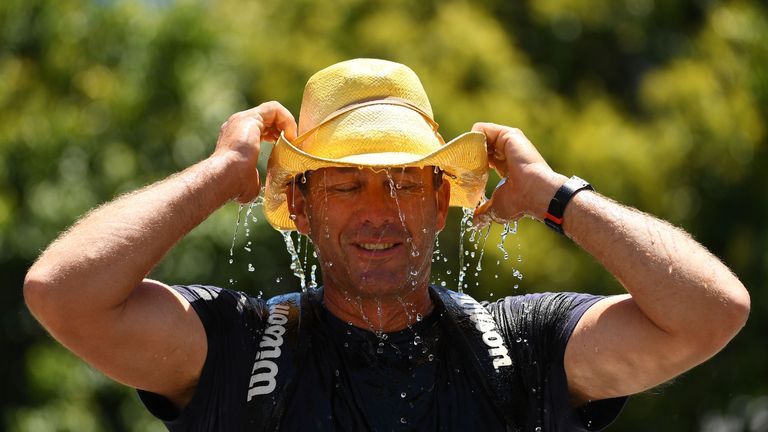 A spectator finds relief from the searing heat at Melbourne Park
