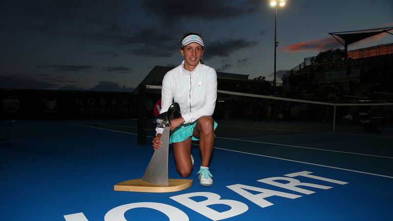 Elise Mertens of Belgium poses with the winner's trophy after she defeated Mihaela Buzarnescu of Romania