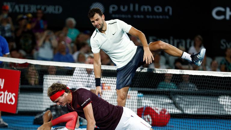 Nick Kyrgios of Australia lies on the ground during a Fast Fours Exhibtion doubles match against Alexander Zverev and Grigor Dimitrov