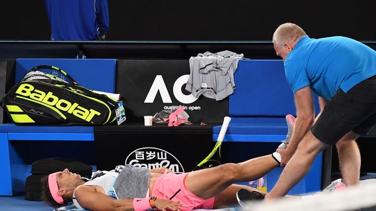 Rafael Nadal receives medical attention during his men's singles quarter-finals match against Marin Cilic at the Australian Open