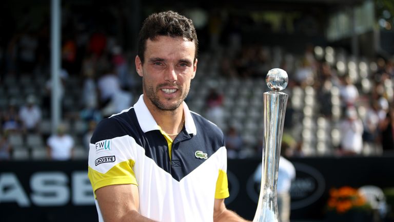 Roberto Bautista Agut of Spain poses with the trophy following his Mens Singles Final win over Juan Martin Del Potro