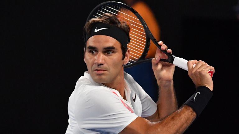 Switzerland's Roger Federer hits a return against Croatia's Marin Cilic during their men's singles final match on day 14 of the Australian Open tennis tour
