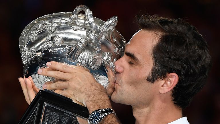 Switzerland's Roger Federer kisses the winner's trophy after beating Croatia's Marin Cilic in their men's singles final at the Australian Open