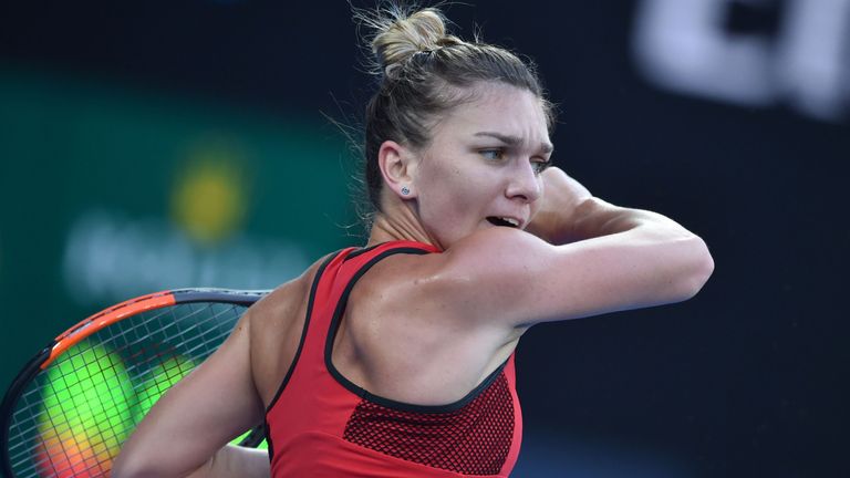 Romania's Simona Halep hits a return against Denmark's Caroline Wozniacki during their women's singles final match on day 13 of the Australian Open