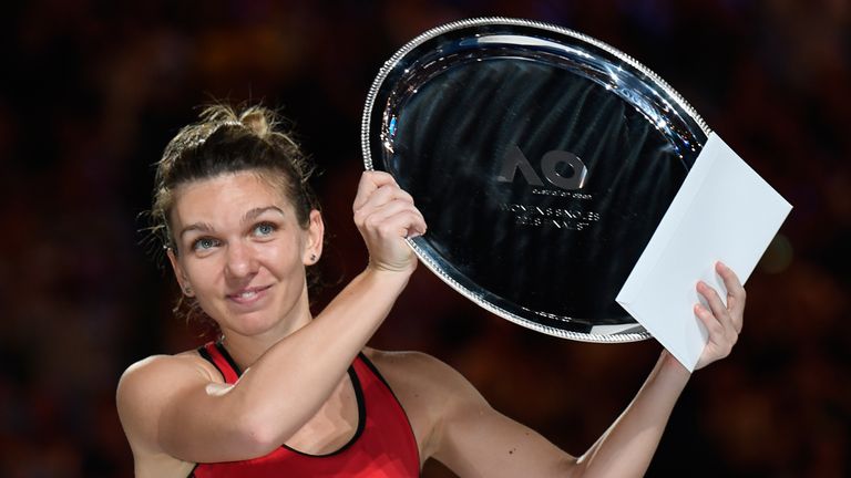 Romania's Simona Halep holds up the runners-up trophy after losing to Denmark's Caroline Wozniacki in their women's singles final