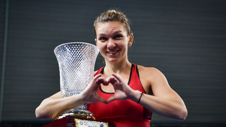 Simona Halep celebrates with the trophy after her victory against Katerina Siniakova n the women's singles final match at the WTA Shenzhen Open