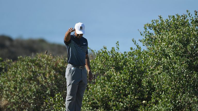 Tiger Woods drops his ball on the 13th hole during the second round of the Farmers Insurance Open at Torrey Pines North