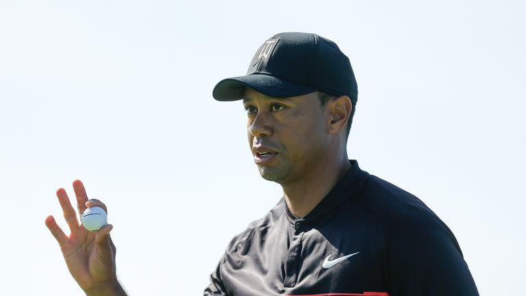 SAN DIEGO, CA - JANUARY 25:  Tiger Woods acknowledges the crowd after a putt on the fourth green during the first round of the Farmers Insurance Open at To