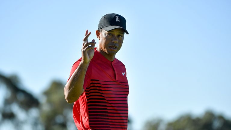 SAN DIEGO, CA - JANUARY 28:  Tiger Woods motions to the crowd after a putt on the 14th green during the final round of the Farmers Insurance Open at Torrey