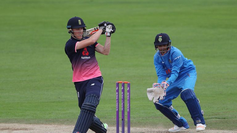 Tom Banton of England U19s hits out as India U19s wicket keeper Het Patel looks on