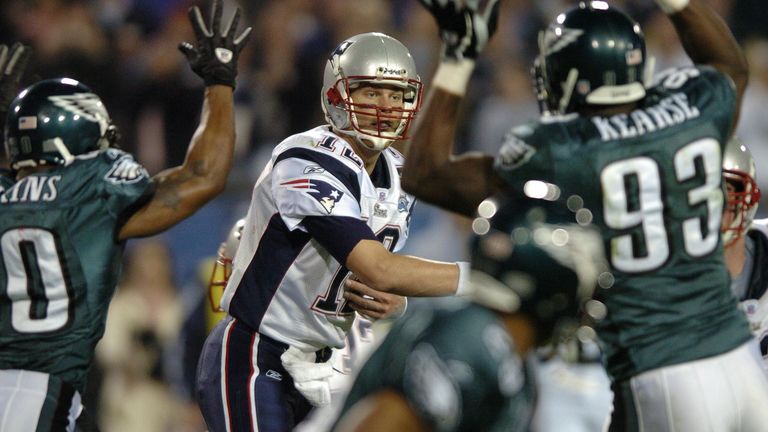 JACKSONVILLE, UNITED STATES:  New England Patriots quarterback Tom Brady (C) throws a pass while being pressured by the Philadelphia Eagles defense during 