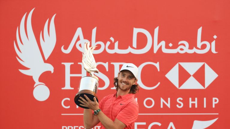 Tommy Fleetwood of England celebrates with the winner's trophy after the final round of the Abu Dhabi HSBC Championship