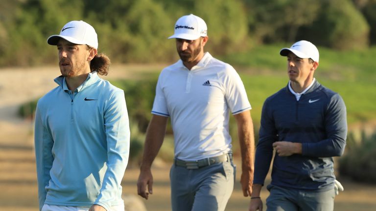 ABU DHABI, UNITED ARAB EMIRATES - JANUARY 18:  Tommy Fleetwood of England, Dustin Johnson of the United States and Rory McIlroy of Northern Ireland walk on