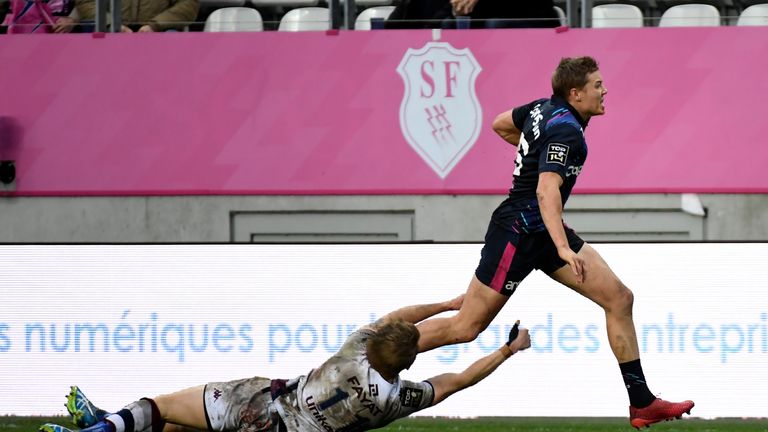 Stade Francais' Tony Ensor (R) runs with the ball during the French Top 14 rugby union match between Stade Francais and Bordeaux-Begles at the Jean Bouin s