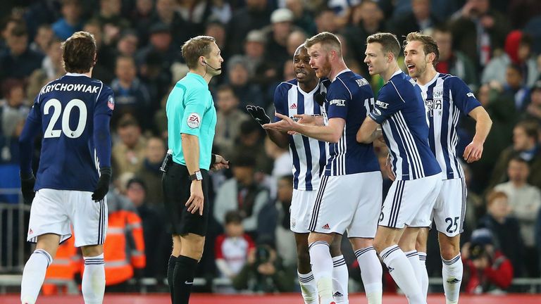 LIVERPOOL, ENGLAND - JANUARY 27:  West Bromwich Albion players argue with the referee after he uses the VAR system and awards a penalty to Liverpool  durin