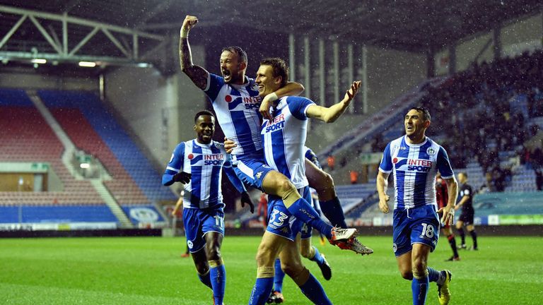 WIGAN, ENGLAND - JANUARY 17:  Daniel Burn of Wigan celebrates with team mates after scoring his side second goal during The Emirates FA Cup Third Round Rep