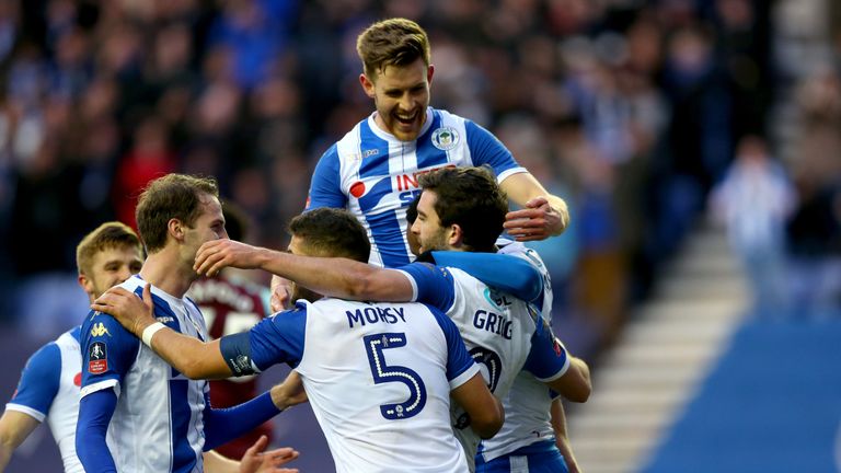 WIGAN, ENGLAND - JANUARY 27:  William Grigg of Wigan Athletic celebrates after scoring his sides second goal with his team mates during The Emirates FA Cup