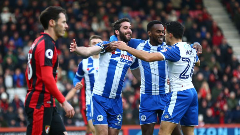 Will Grigg (L) of Wigan Athletic celebrates scoring the opening goal with Gavin Massey (C) and Reece James v Bournemouth in the FA Cup