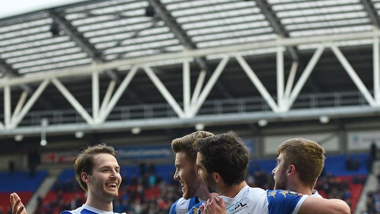 Will Grigg celebrates with team-mates