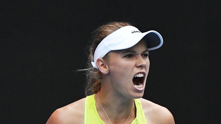 MELBOURNE, AUSTRALIA - JANUARY 15:  Caroline Wozniacki of Denmark celebrates winning a point in her first round match against Mihaela Buzarnescu of Romaini