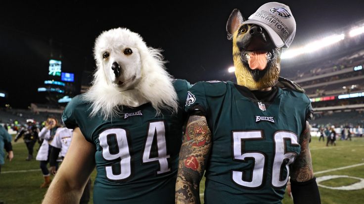 PHILADELPHIA, PA - JANUARY 21: Beau Allen #94 and Chris Long #56 of the Philadelphia Eagles celebrates their teams win while wearing a dog masks over the M