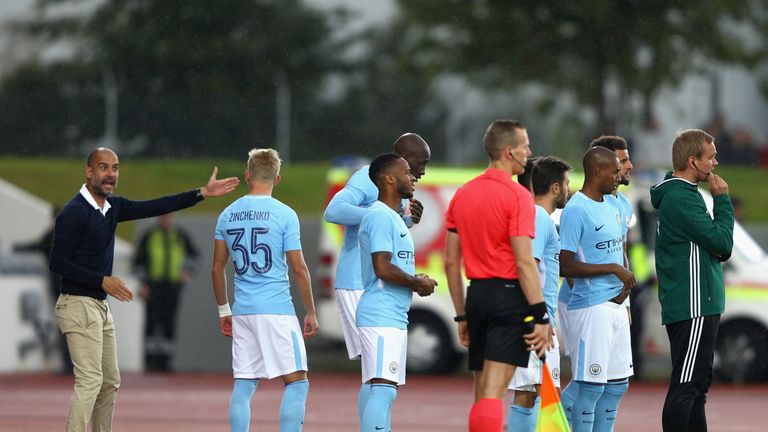 Pep Guardiola, Manager of Manchester City speaks to Oleksandr Zinchenko of Manchester City during a pre-season friendly in Iceland