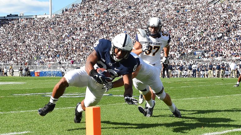 STATE COLLEGE, PA - SEPTEMBER 3:  Saquon Barkley #26 of the Penn State Nittany Lions dives for a touchdown in front of Nick Cuthbert #37 of the Kent State 