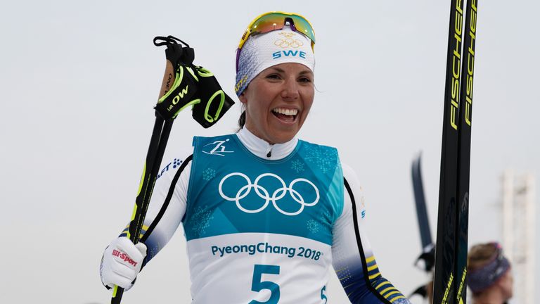 Sweden's Charlotte Kalla celebrates winning the first gold medal of the 2018 Winter Olympics