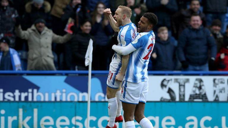 Alex Pritchard celebrates with team-mate Steve Mounie