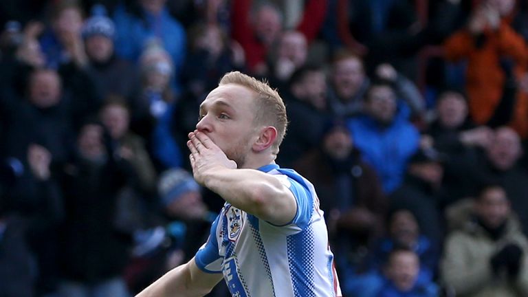 Alex Pritchard of Huddersfield Town celebrates after scoring his sides first goal during the Premier League match on February 11