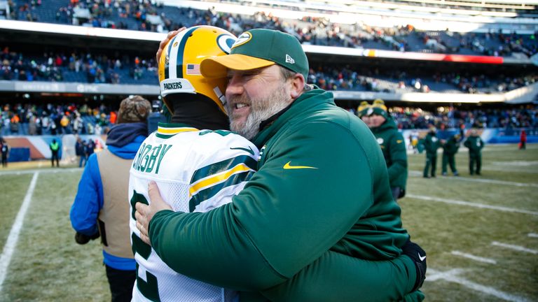 CHICAGO, IL - DECEMBER 18:  Kicker Mason Crosby #2 of the Green Bay Packers hugs quarterbacks coach Alex Van Pelt after winning the game at Soldier Field o